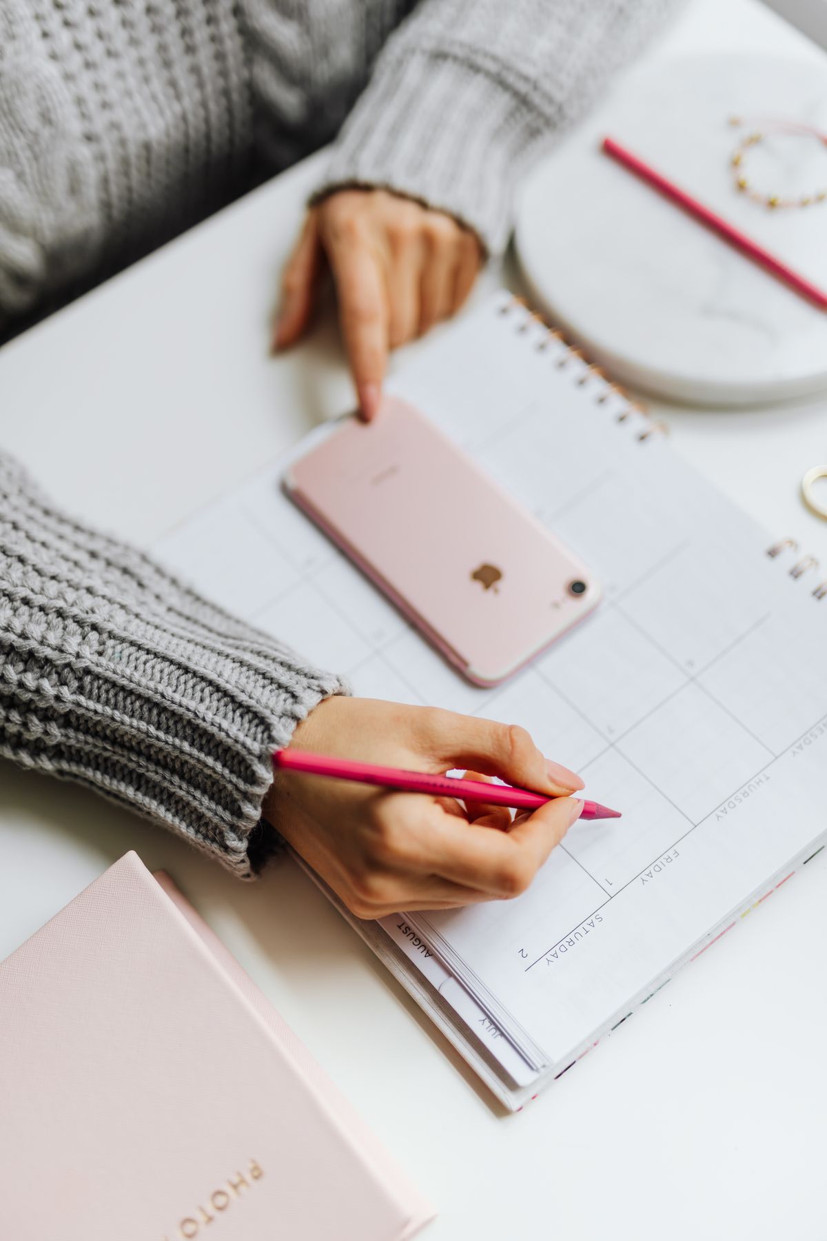 A person on the phone looking at a calendar, dealing with a cancelled NDIS appointment