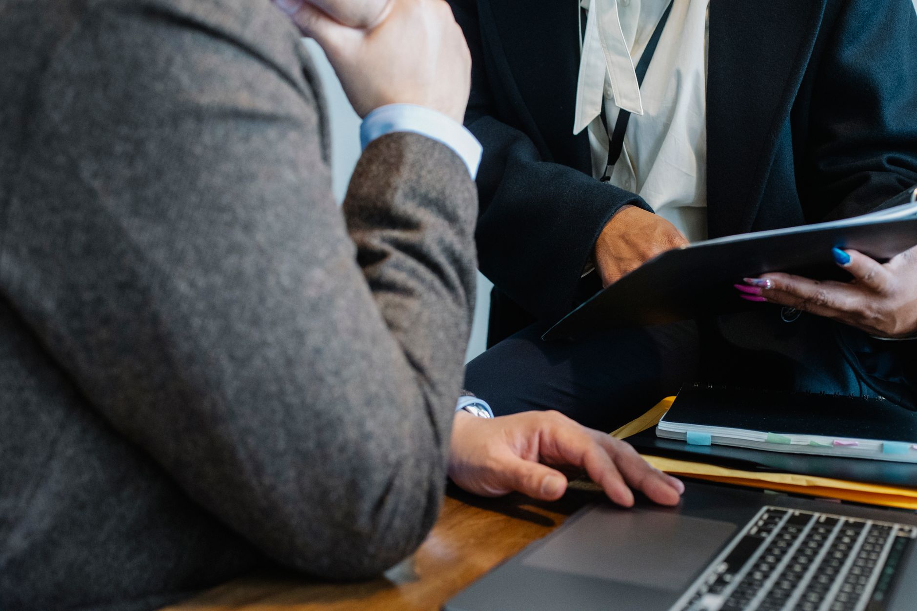 Two professionals in a collaborative meeting discussing NDIS participant support plans